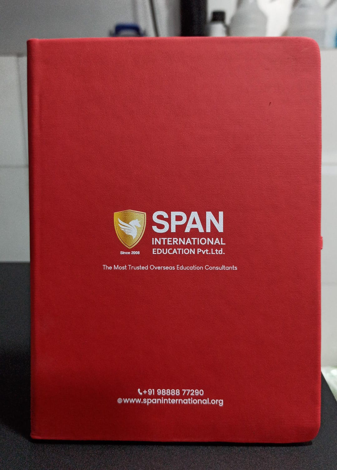 Custom logo A5 notebook in vibrant red featuring a professional design for branding purposes