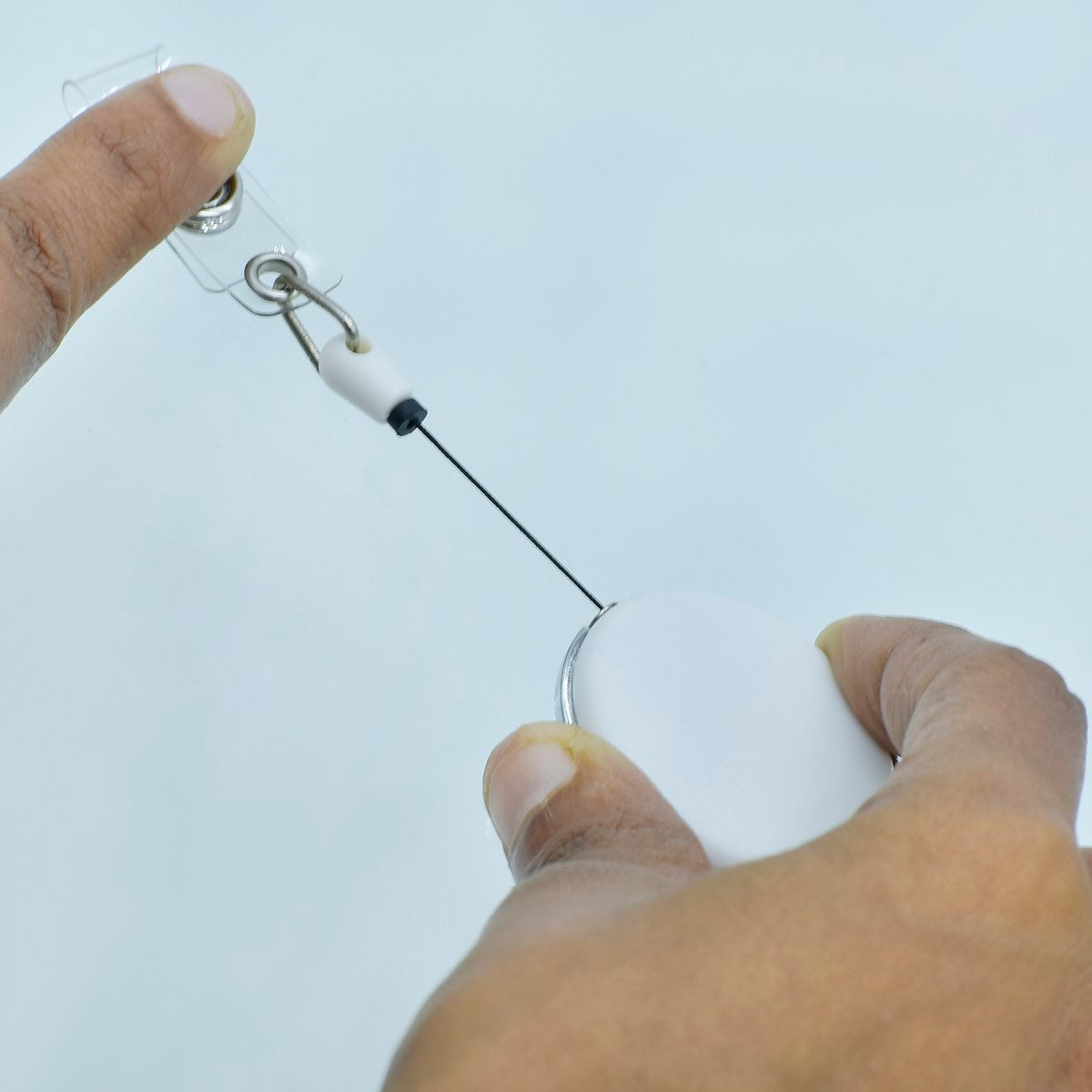 Close-up of a Customized White YoYo Clip in use, showing the clip and string attachment
