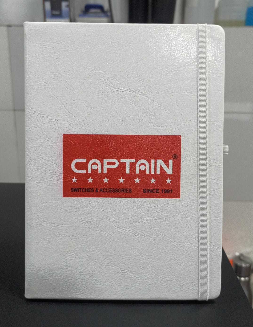 Personalized logo printed A5 notebook with a white cover and red logo design