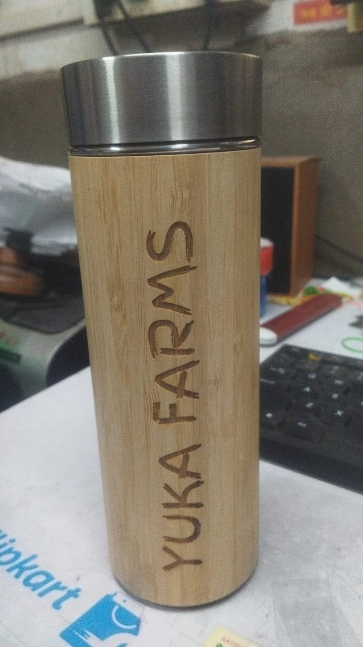 Personalized bamboo water bottle with engraved Yuka Farms design, perfect for eco-friendly hydration