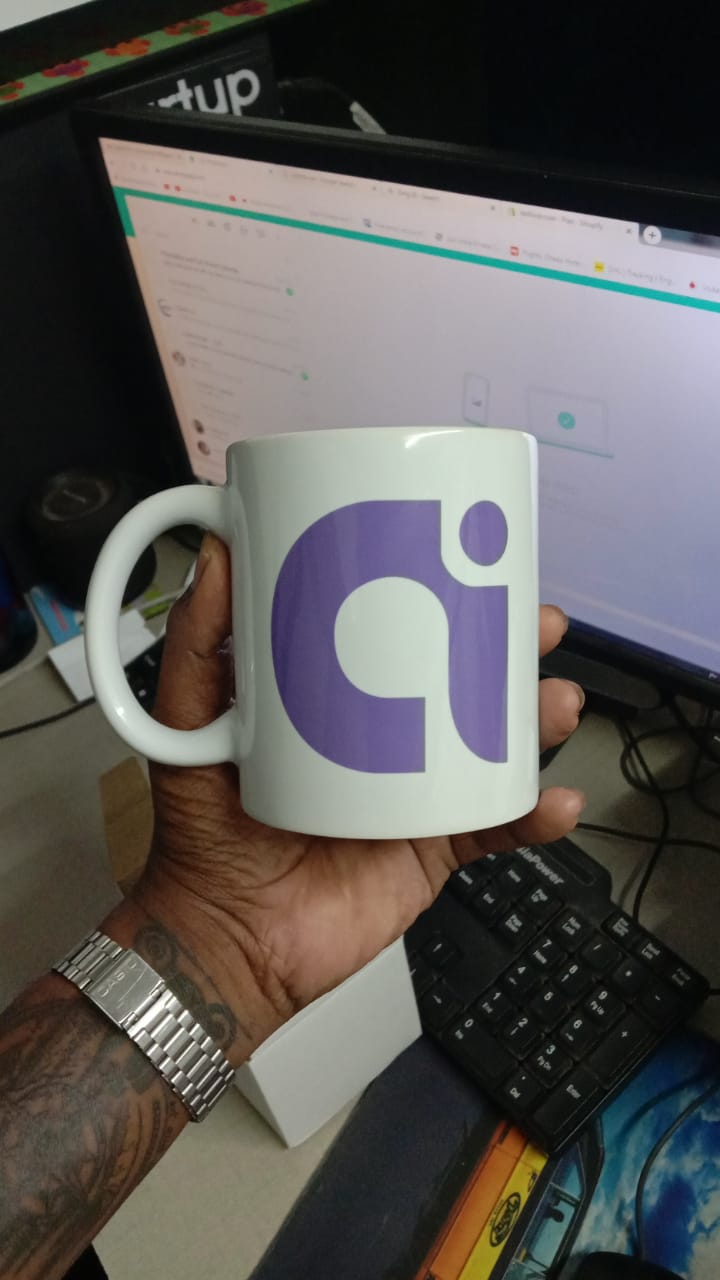Personalized ceramic mug 350ml with a modern design held in a hand against a workspace background