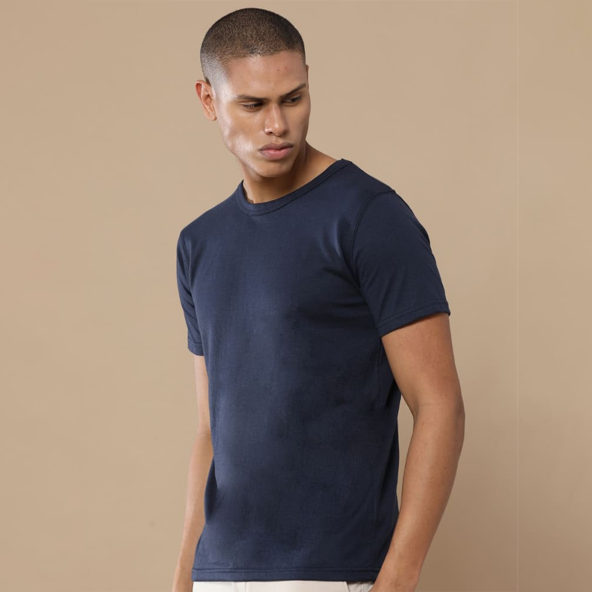 Navy blue crew neck t-shirt with a placeholder design area showing where users can add their own logo, artwork, or text for customization.