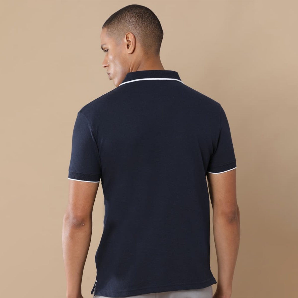 Back view of the personalized navy blue jacquard polo t-shirt showing clean structure and textured fabric finish.