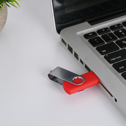 Personalized red USB drive connected to a laptop for easy data storage and transfer