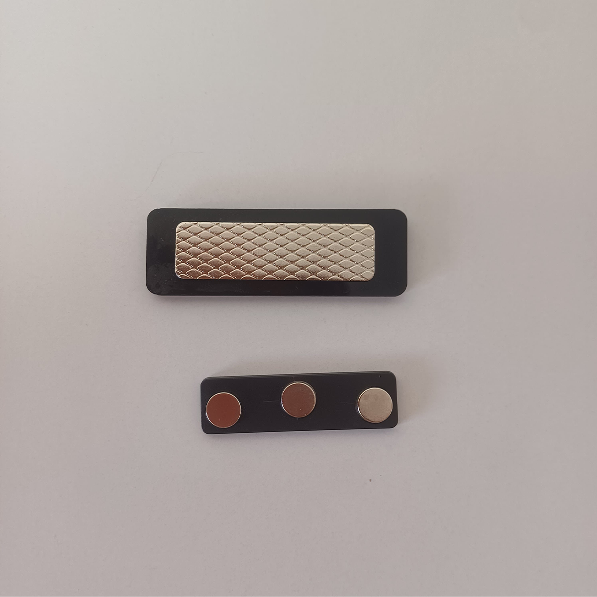Back side of the badge with strong magnetic clip for easy attachment