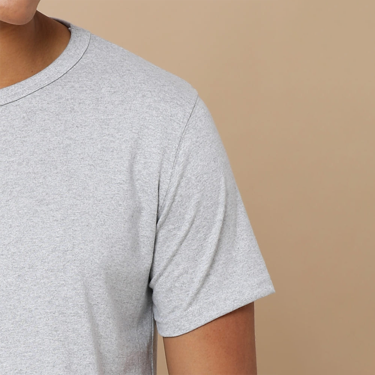 Close-up view of the collar and cuffs on the grey round neck t-shirt, highlighting the textured fabric and fine craftsmanship for a premium look.