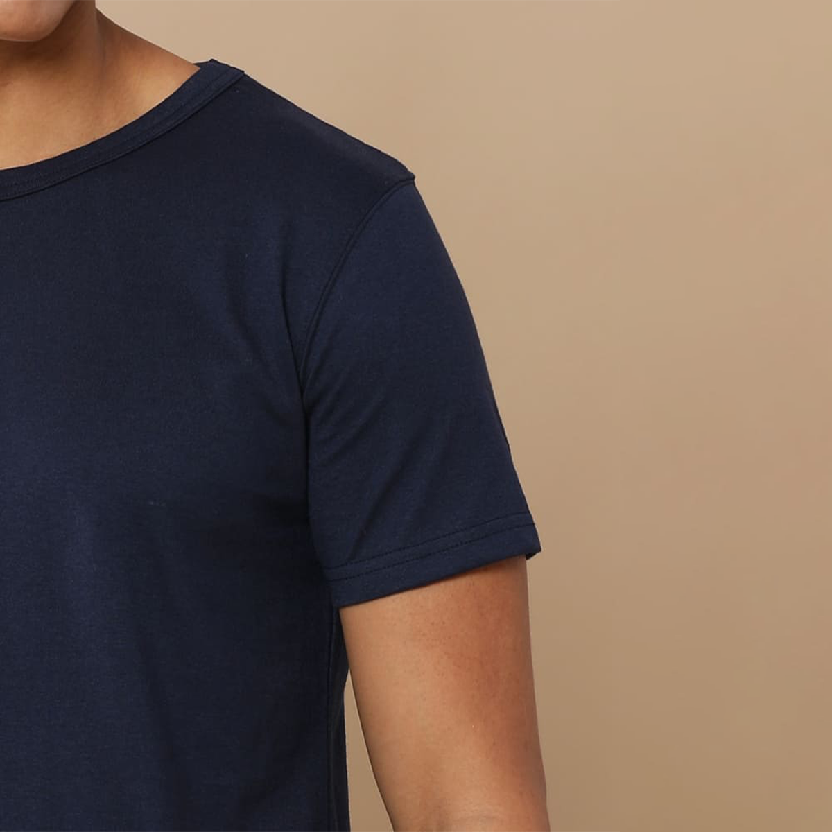 Close-up view of the collar and cuffs on the navy blue round neck t-shirt, highlighting the textured fabric and fine craftsmanship for a premium look.