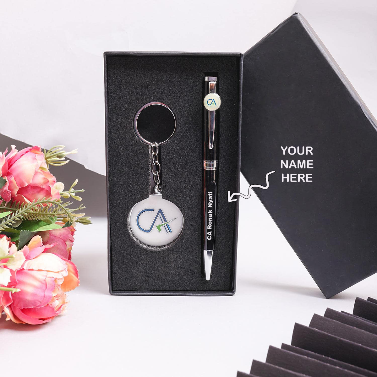 Personalized Pen And Keychain Combo For CA in a gift box with a floral arrangement